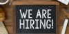 Wooden Sign With the Words We Are Hiring